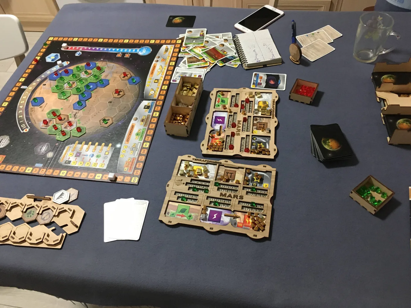 Our Terraforming Mars game in progress: the board, wooden organizer trays and player mats